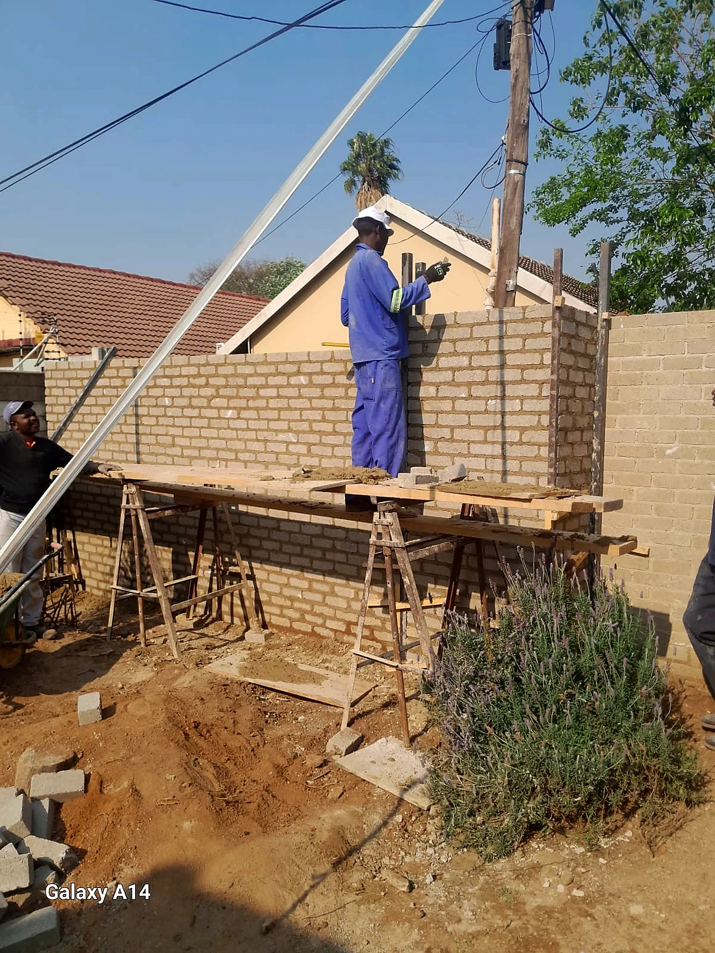 Andy Construction bricklayer building a wall